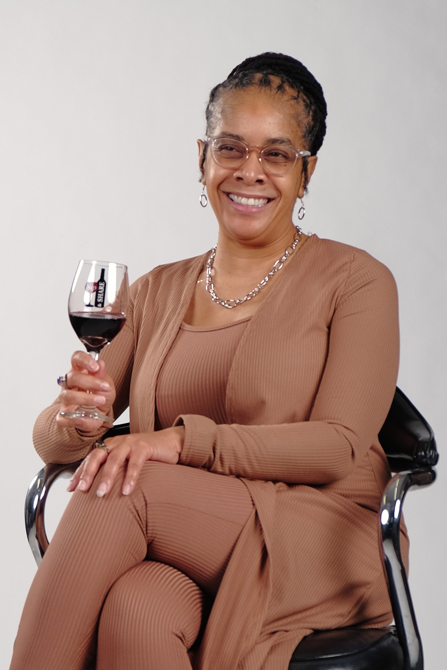 Nicole Kearney poses while holding a glass of red wine.