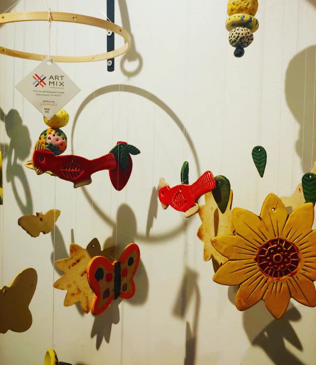 Photo featuring mobiles created through ArtMix featuring birds, butterflies and flowers